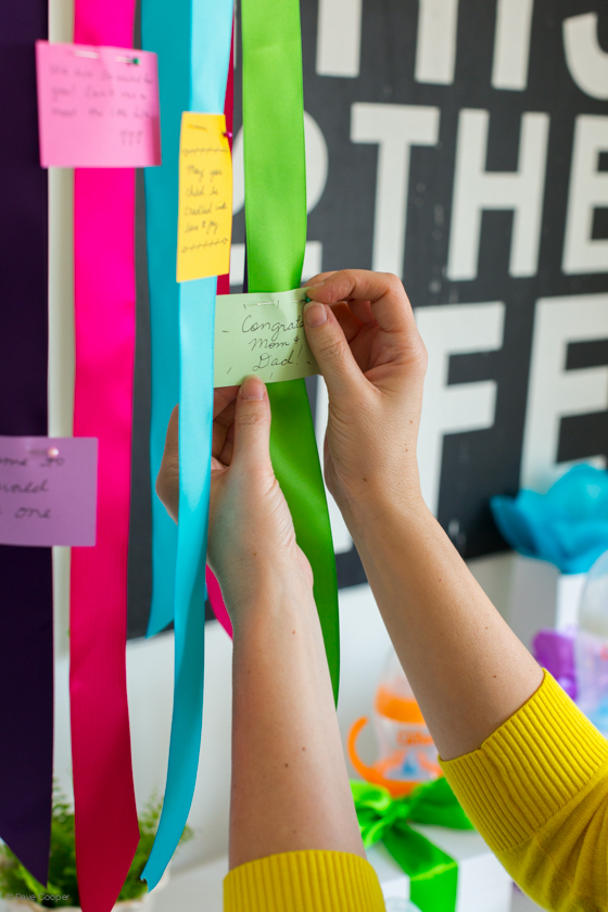 how to create a hanging centerpiece to display at a baby shower covered with well wishes for new parents and baby.